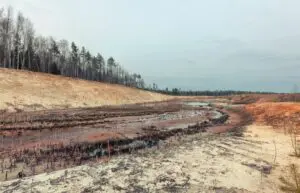 Landscape old waterlogged sand quarry. Environmental pollution