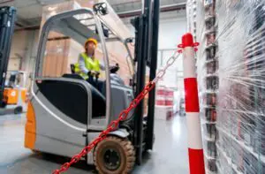 Safety at work with forklift in warehouse