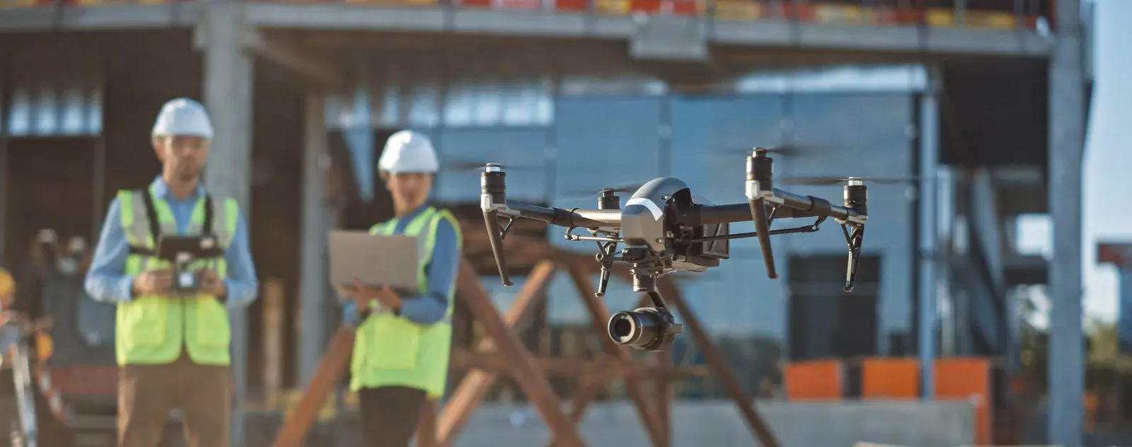 Resources - Engineering 23 Two construction workers operate a survey drone on a work site.