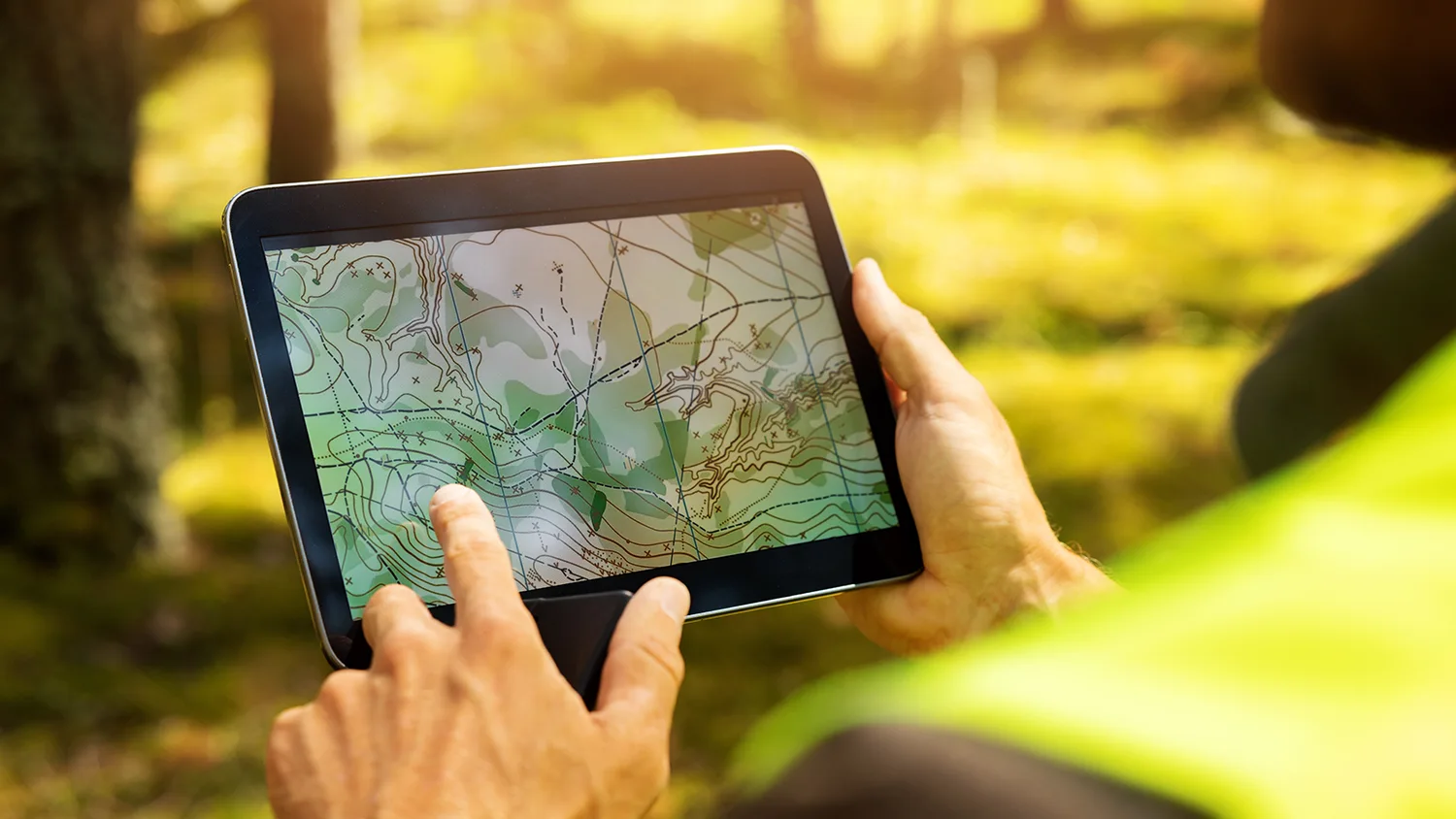 Resources - Engineering 20 A surveyor working with forest topographic survey map on a digital tablet.