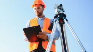 Surveyor man marking land boundary survey with theodolite equipment