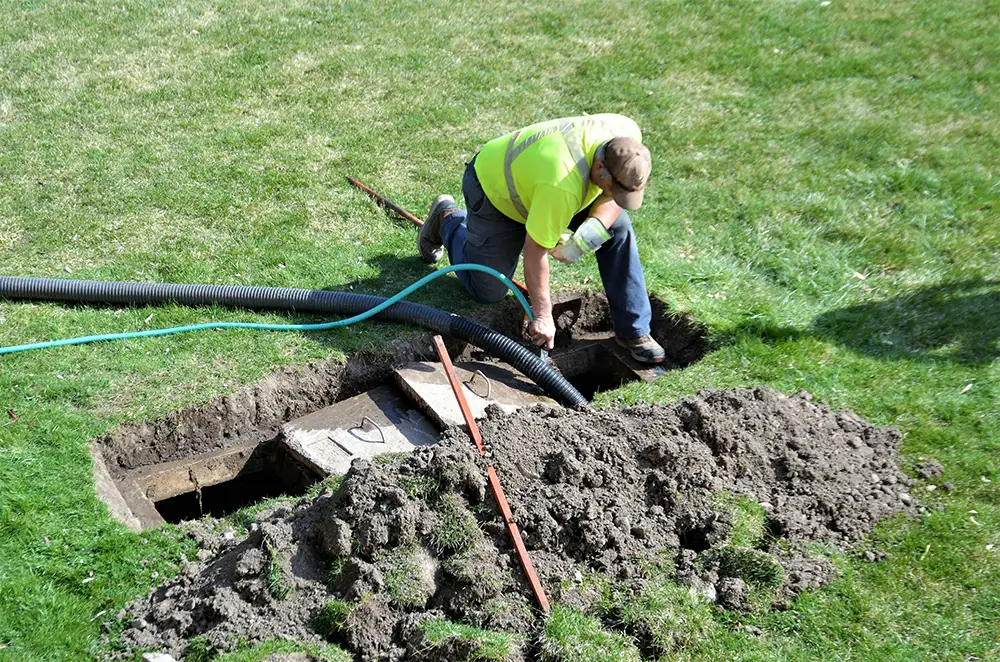 Navigating Septic System Design in Utah: A Comprehensive Guide to Permitting, Soil Testing, and Regulatory Approvals 2 A workman pumping out a septic tank.