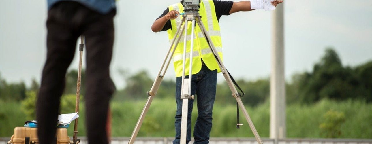 survey engineer in construction site use theodolite mark a concrete pile co ordinate specialists conducting a land survey