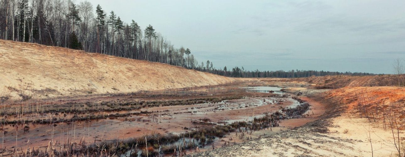 Landscape old waterlogged sand quarry. Environmental pollution Landscape old waterlogged sand quarry. Environmental pollution